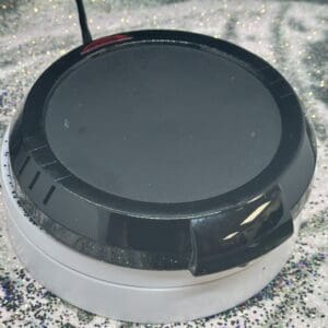 Round electric mug warmer on glittery surface