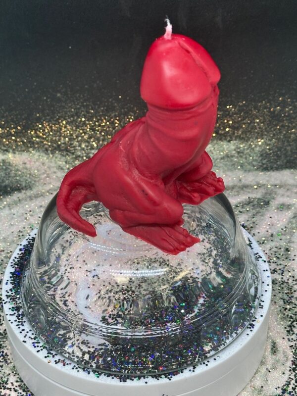 A red glove is on top of a glass bowl.